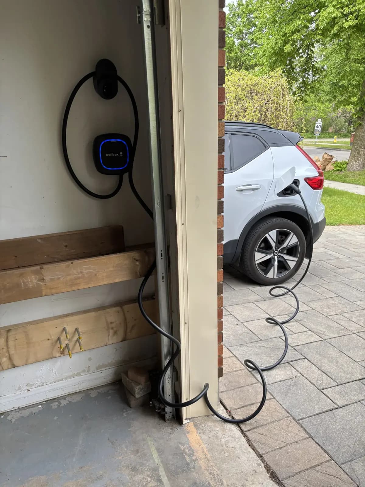 Wallbox EV charger charging an electric SUV in a driveway, installed by Levere Electric